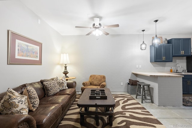 living room with ceiling fan and sink