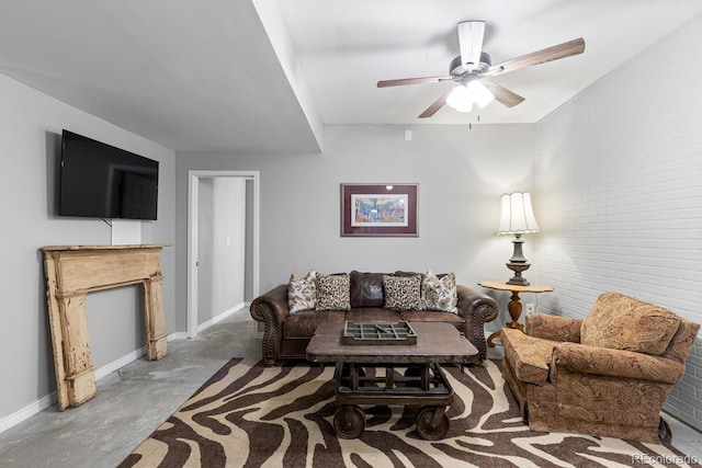 living room featuring ceiling fan, concrete flooring, and brick wall