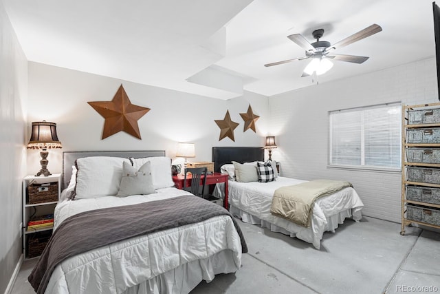 bedroom featuring ceiling fan and brick wall