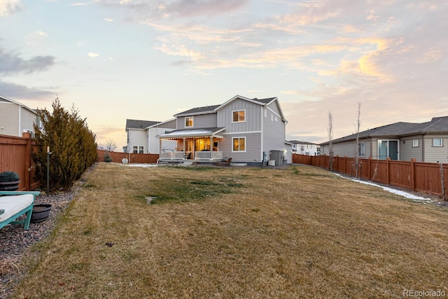 back house at dusk with a yard