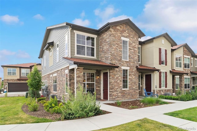 8387 Donati Ter Unit A, Littleton, CO 80129 - view of front of home featuring stone siding and a front lawn