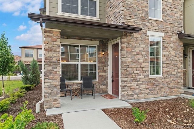 8387 Donati Ter Unit A, Littleton, CO 80129 - property entrance with covered porch and stone siding