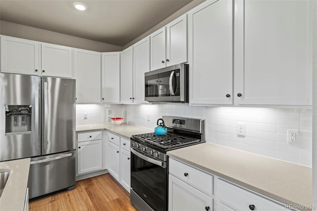 8387 Donati Ter Unit A, Littleton, CO 80129 - kitchen featuring appliances with stainless steel finishes, light countertops, light wood-type flooring, and recessed lighting