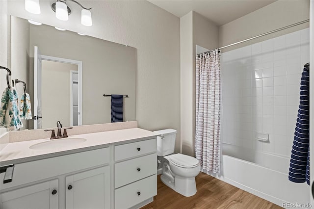 8387 Donati Ter Unit A, Littleton, CO 80129 - full bathroom featuring wood finished floors, vanity, and shower / bath combo with shower curtain