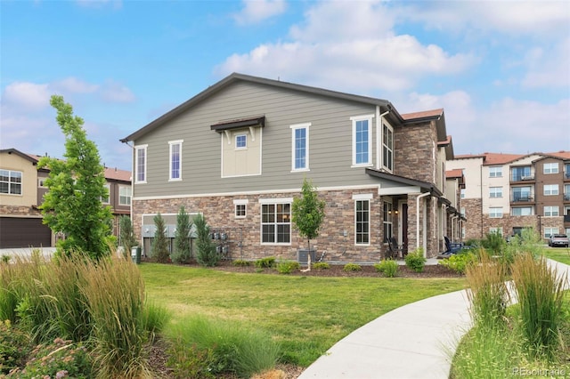 8387 Donati Ter Unit A, Littleton, CO 80129 - view of front facade featuring stone siding and a front yard