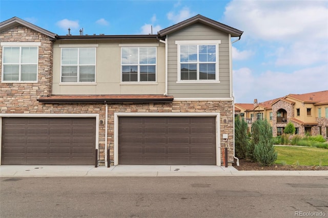 8387 Donati Ter Unit A, Littleton, CO 80129 - view of front of house featuring stone siding and an attached garage