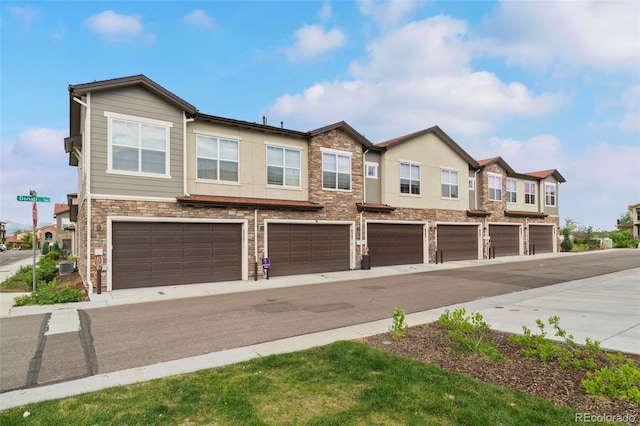 8387 Donati Ter Unit A, Littleton, CO 80129 - multi unit property featuring stone siding, an attached garage, and a residential view