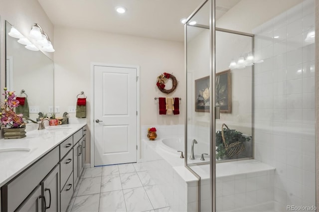 bathroom featuring vanity and independent shower and bath