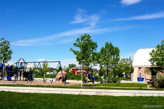 community jungle gym featuring a lawn