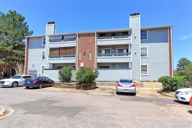 14204 E 1st Dr Unit A12, Aurora, CO 80011 - view of building exterior featuring uncovered parking