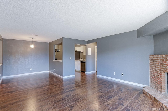 14204 E 1st Dr Unit A12, Aurora, CO 80011 - unfurnished living room with dark wood-style floors, a textured ceiling, and a fireplace