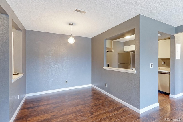 14204 E 1st Dr Unit A12, Aurora, CO 80011 - empty room featuring dark wood finished floors, a textured wall, and a textured ceiling