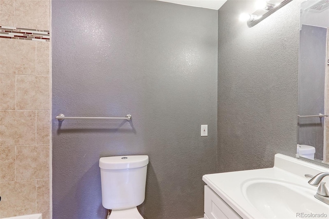 14204 E 1st Dr Unit A12, Aurora, CO 80011 - bathroom with vanity and a textured wall
