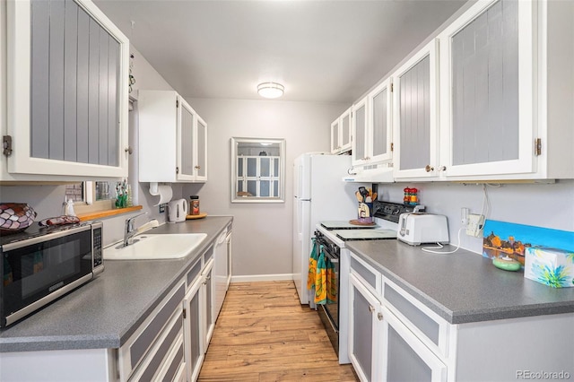4541 W Ponds Cir, Littleton, CO 80123 - kitchen with white appliances, light wood-style floors, white cabinets, under cabinet range hood, and dark countertops