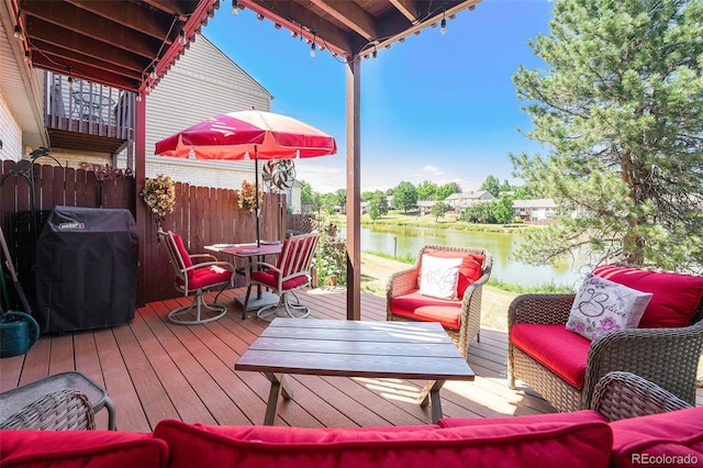 4541 W Ponds Cir, Littleton, CO 80123 - wooden deck featuring outdoor dining space, area for grilling, a water view, and an outdoor hangout area