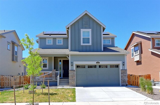 craftsman-style house with solar panels, a garage, and a front lawn