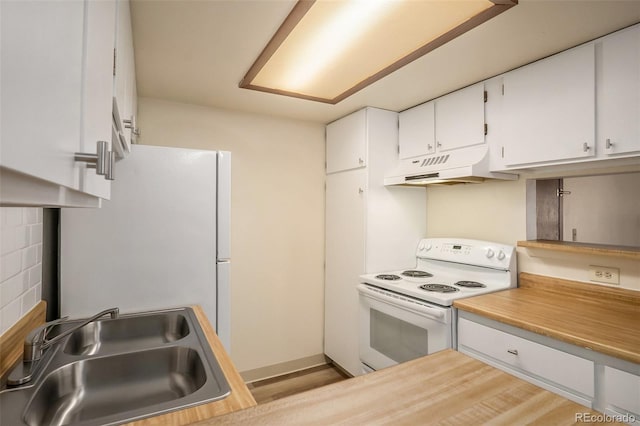 kitchen featuring under cabinet range hood, light countertops, white cabinets, white appliances, and a sink