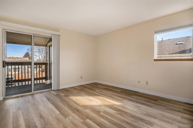 unfurnished room featuring wood finished floors and baseboards