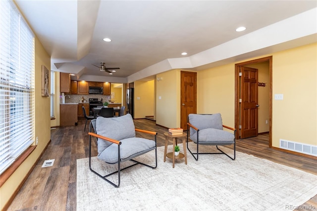 living room featuring sink, wood-type flooring, and ceiling fan