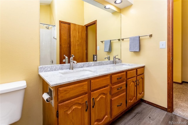 bathroom with vanity, hardwood / wood-style floors, and toilet