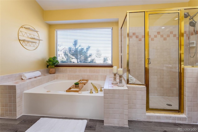 bathroom featuring independent shower and bath