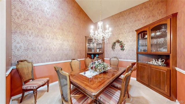 dining room featuring light colored carpet, a chandelier, vaulted ceiling, and wallpapered walls