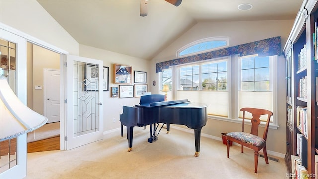 living area featuring visible vents, a ceiling fan, carpet flooring, and lofted ceiling