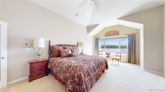 bedroom featuring a ceiling fan, vaulted ceiling, baseboards, a water view, and light carpet