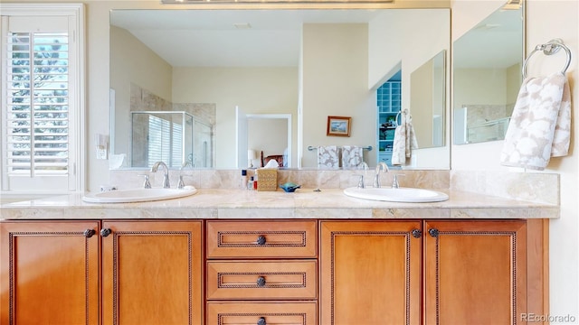 full bath with double vanity, a sink, and a stall shower