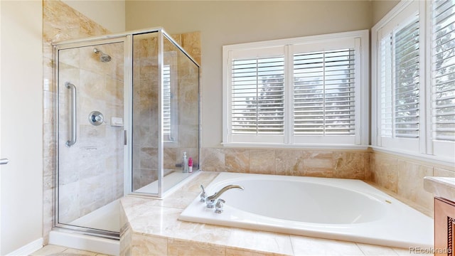 full bathroom featuring plenty of natural light and a shower stall