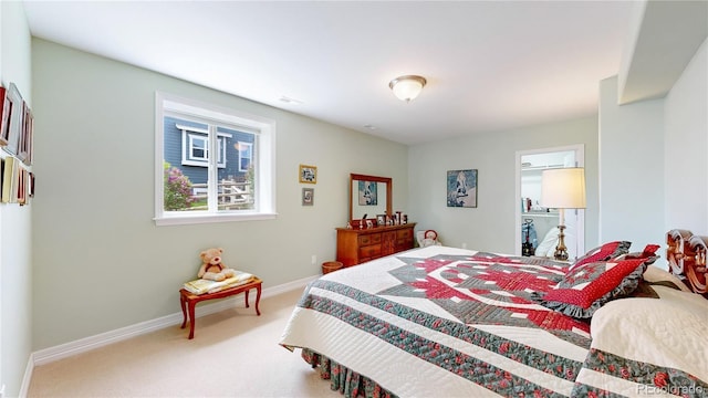 carpeted bedroom featuring baseboards and visible vents