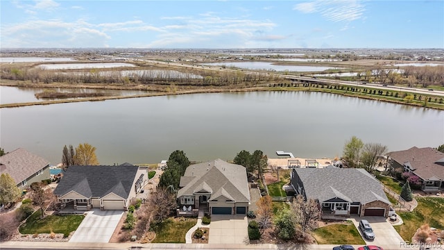bird's eye view featuring a water view and a residential view