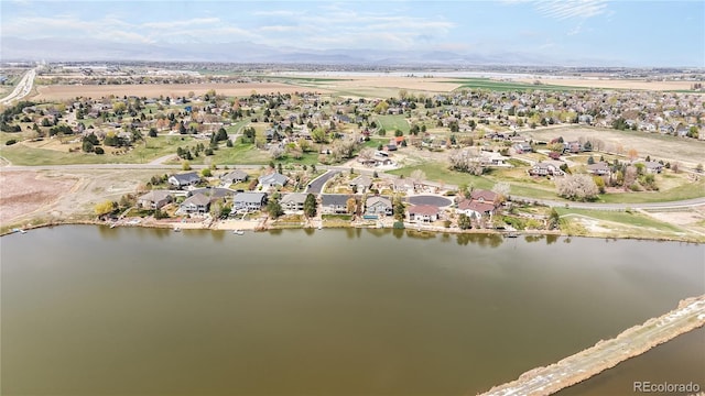 bird's eye view featuring a water view and a residential view