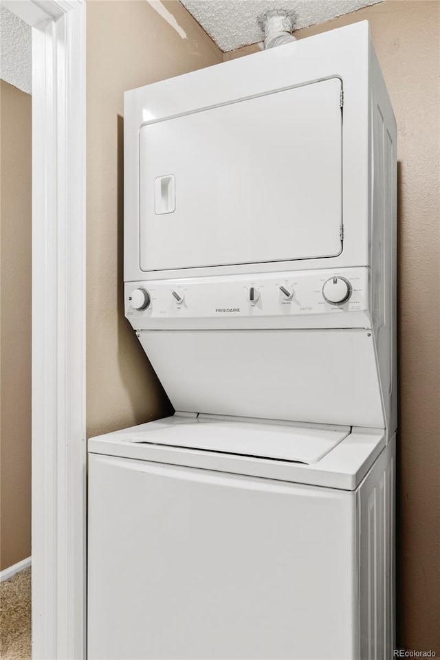 8100 W Quincy Ave Unit K3, Littleton, CO 80123 - laundry room featuring stacked washer / dryer