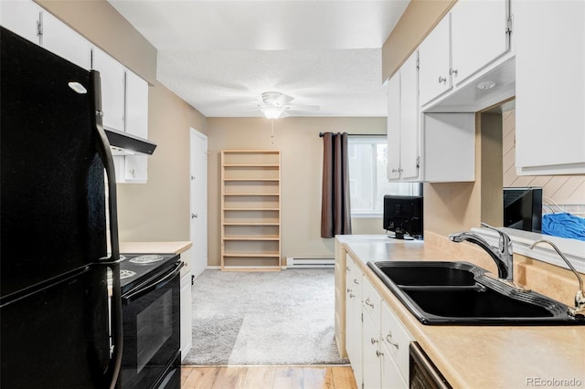 8100 W Quincy Ave Unit K3, Littleton, CO 80123 - kitchen with black appliances, under cabinet range hood, light countertops, ceiling fan, and a baseboard radiator