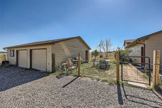 detached garage featuring fence