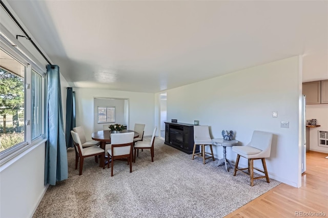 interior space with heating unit, light wood-type flooring, and plenty of natural light