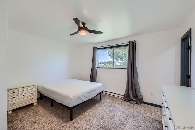 carpeted bedroom with ceiling fan and baseboard heating