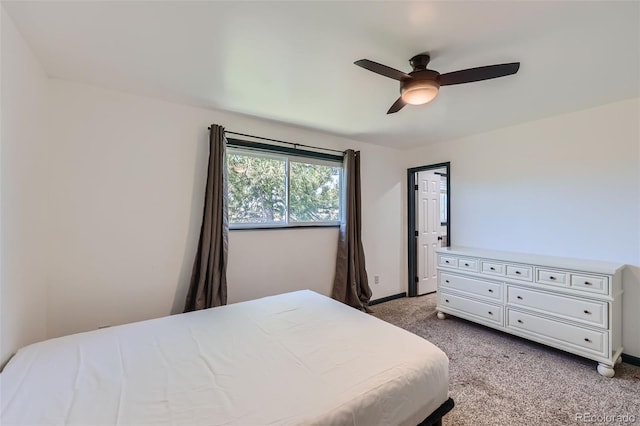 bedroom with baseboards, ceiling fan, and light carpet