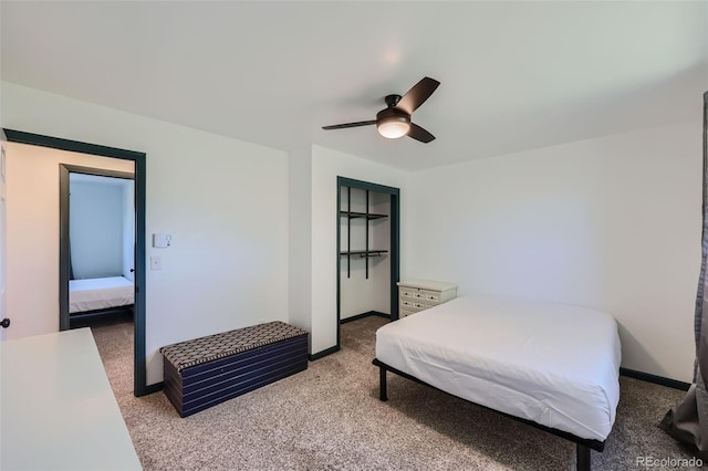 bedroom featuring a ceiling fan, baseboards, and light carpet