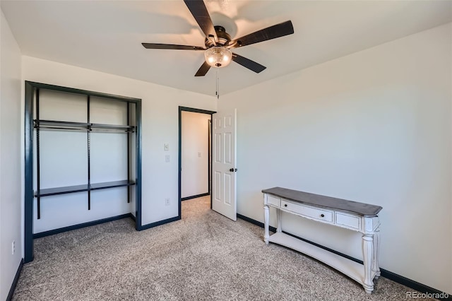 unfurnished bedroom featuring ceiling fan, a closet, and carpet