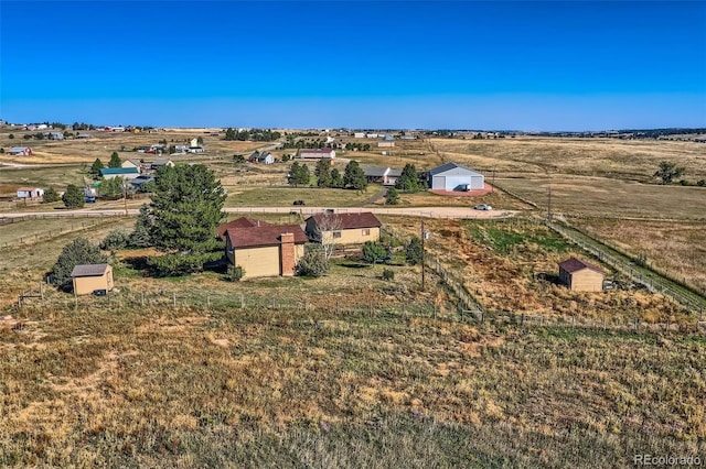 birds eye view of property with a rural view