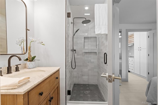 bathroom featuring vanity and an enclosed shower