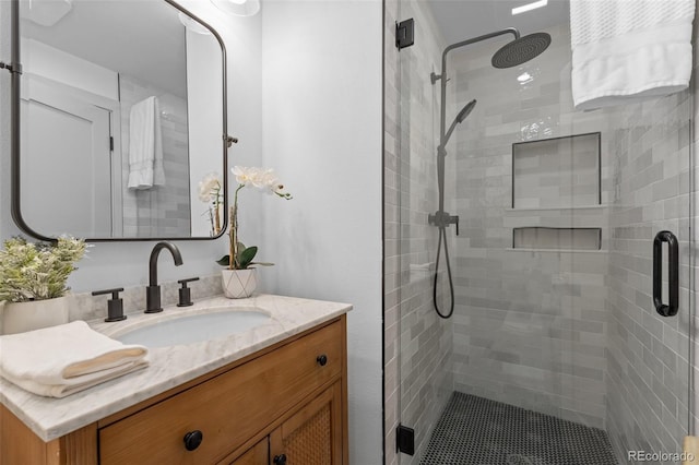 bathroom featuring vanity and a shower with shower door