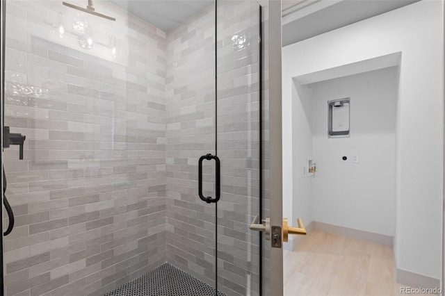 bathroom featuring hardwood / wood-style flooring and walk in shower