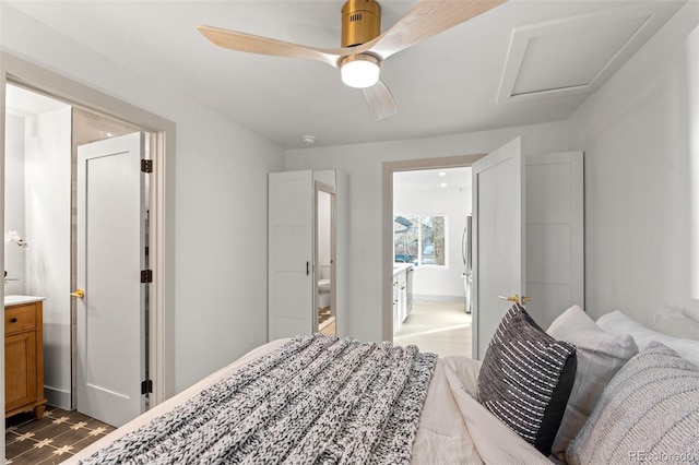 bedroom featuring ensuite bath, stainless steel refrigerator, and ceiling fan