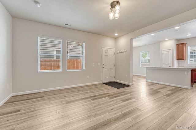 unfurnished living room featuring light wood-type flooring