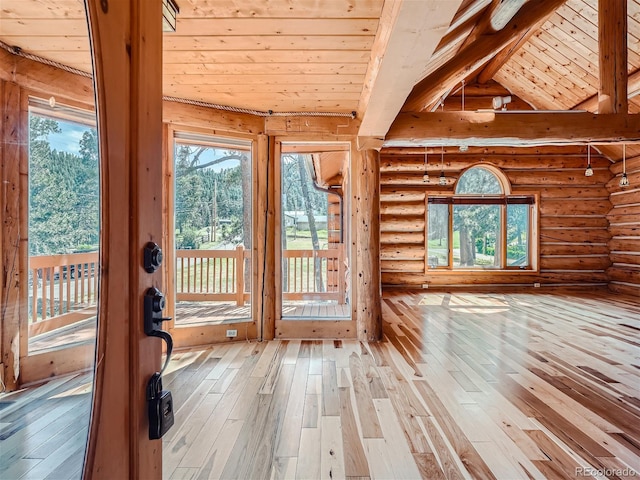 doorway with hardwood / wood-style floors, a wealth of natural light, lofted ceiling with beams, and wooden ceiling