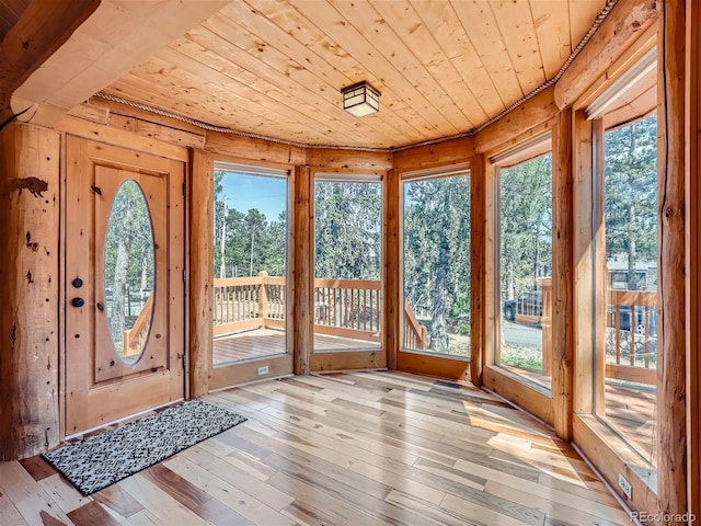 unfurnished sunroom featuring wood ceiling