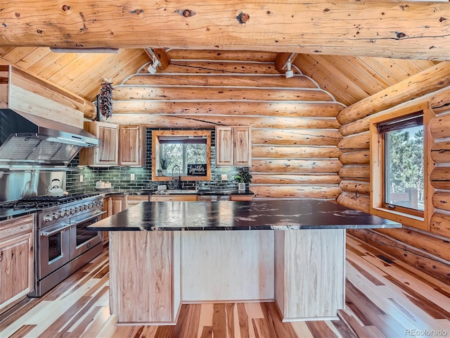 kitchen featuring range with two ovens, exhaust hood, a kitchen island, and light brown cabinets